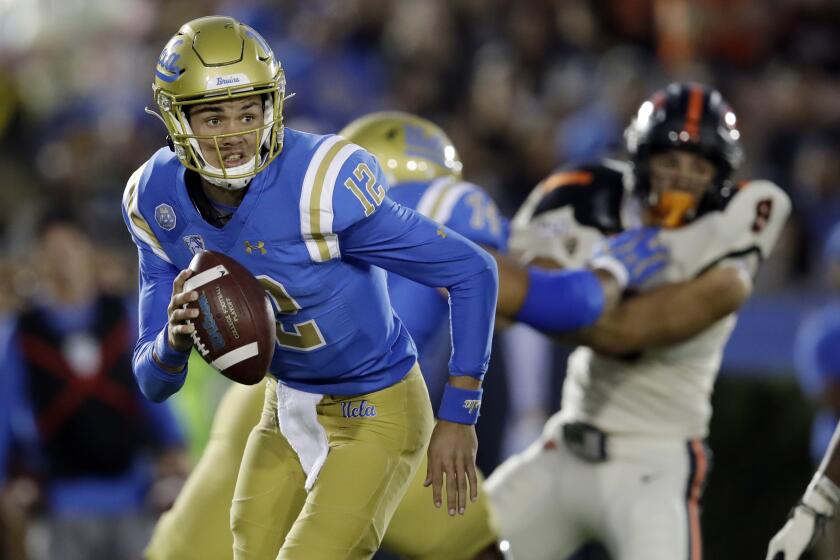 UCLA quarterback Austin Burton (12) runs out of the pocket against Oregon State during the first half of an NCAA college football game Saturday, Oct. 5, 2019, in Pasadena, Calif. (AP Photo/Marcio Jose Sanchez)