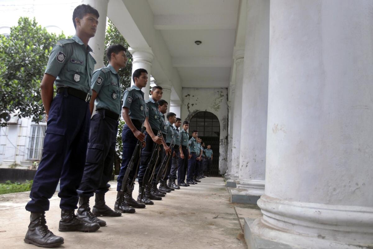 Bangladeshi police officers stand guard outside a special war crimes tribunal in Dhaka.