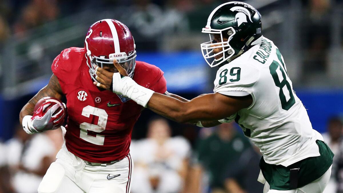 Running back Derrick Henry, fending off Michigan State defensive end Shilique Calhoun during a touchdown run Thursday night, and Alabama will play for national title on Jan. 11 against Clemson.