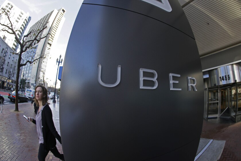 A woman leaves the headquarters of Uber in San Francisco last December.