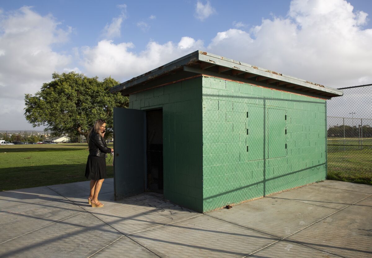 Maria Pelayo of San Diego American Little League opens to door to the snack bar at Memorial Park in Logan Heights.