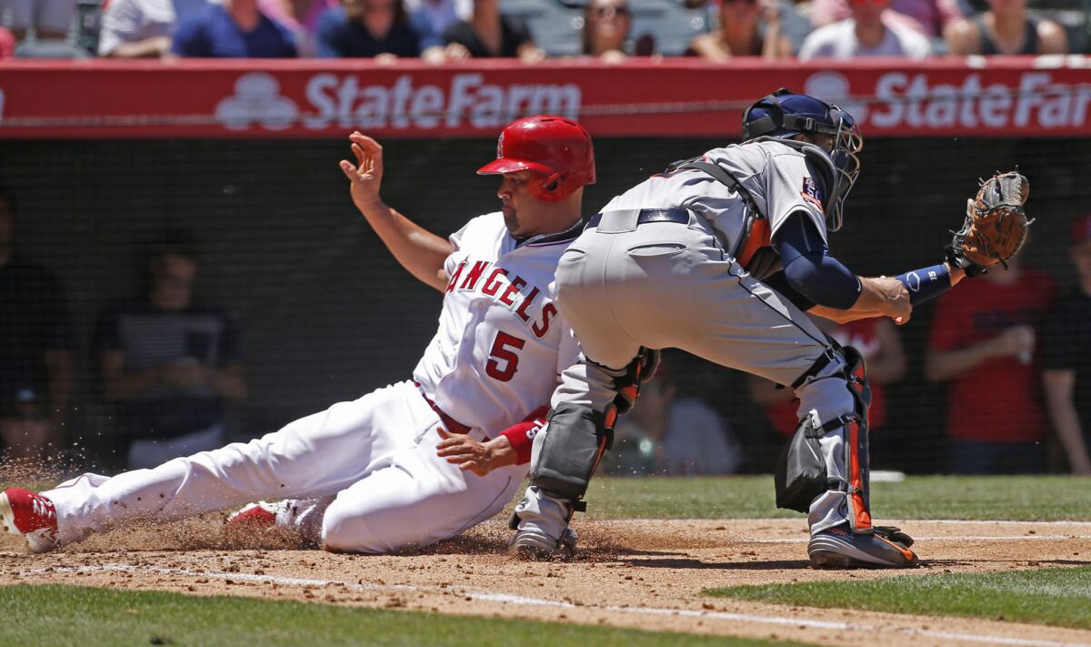 Angels first baseman Albert Pujols slides safetly into home on a sacrifice during the third inning of a game against the Houston Astros. The Angels beat the Astros, 2-1.