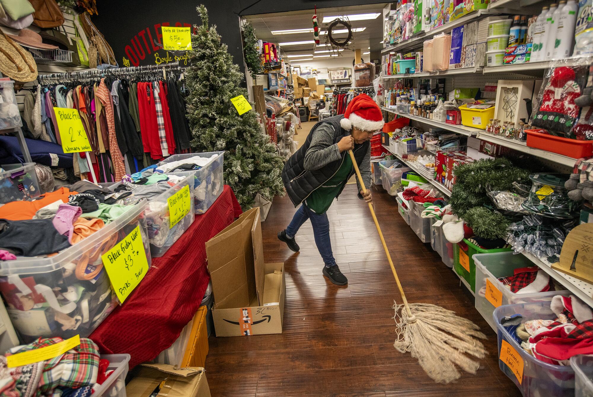 Flavia Cortez cleans an outlet store on Cesar Chavez Boulevard in Boyle Heights.
