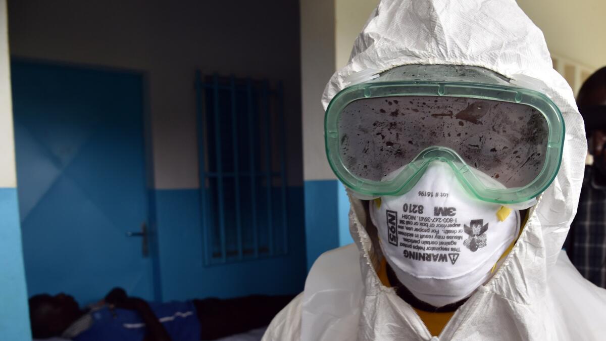 A nurse leaves an isolation room while taking part in an Ebola outbreak simulation exercise in the Ivory Coast on Aug. 14.