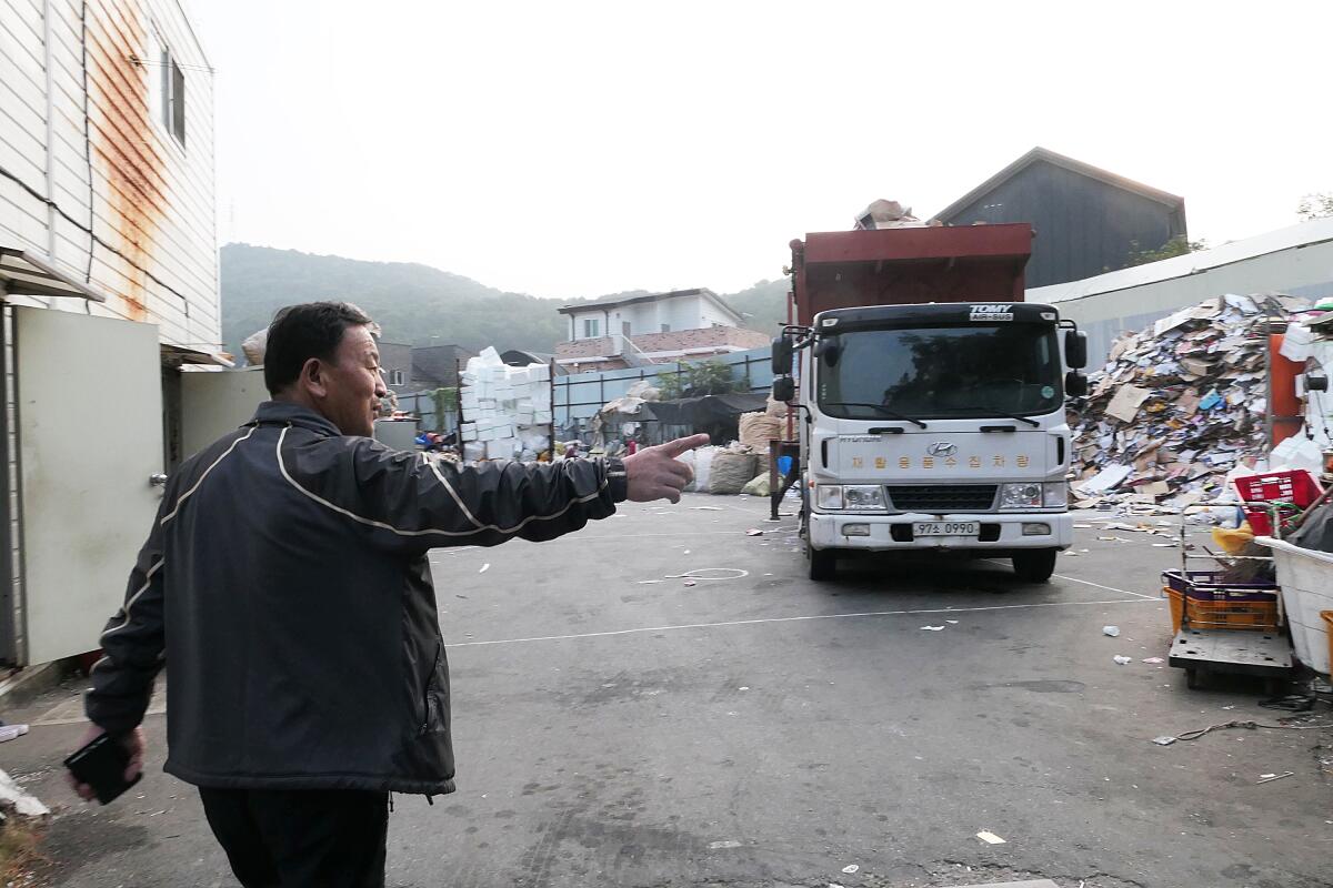 Lee Yong-gi, a operator of a recycling collection company, walks through his recycling center in Goyang, South Korea.