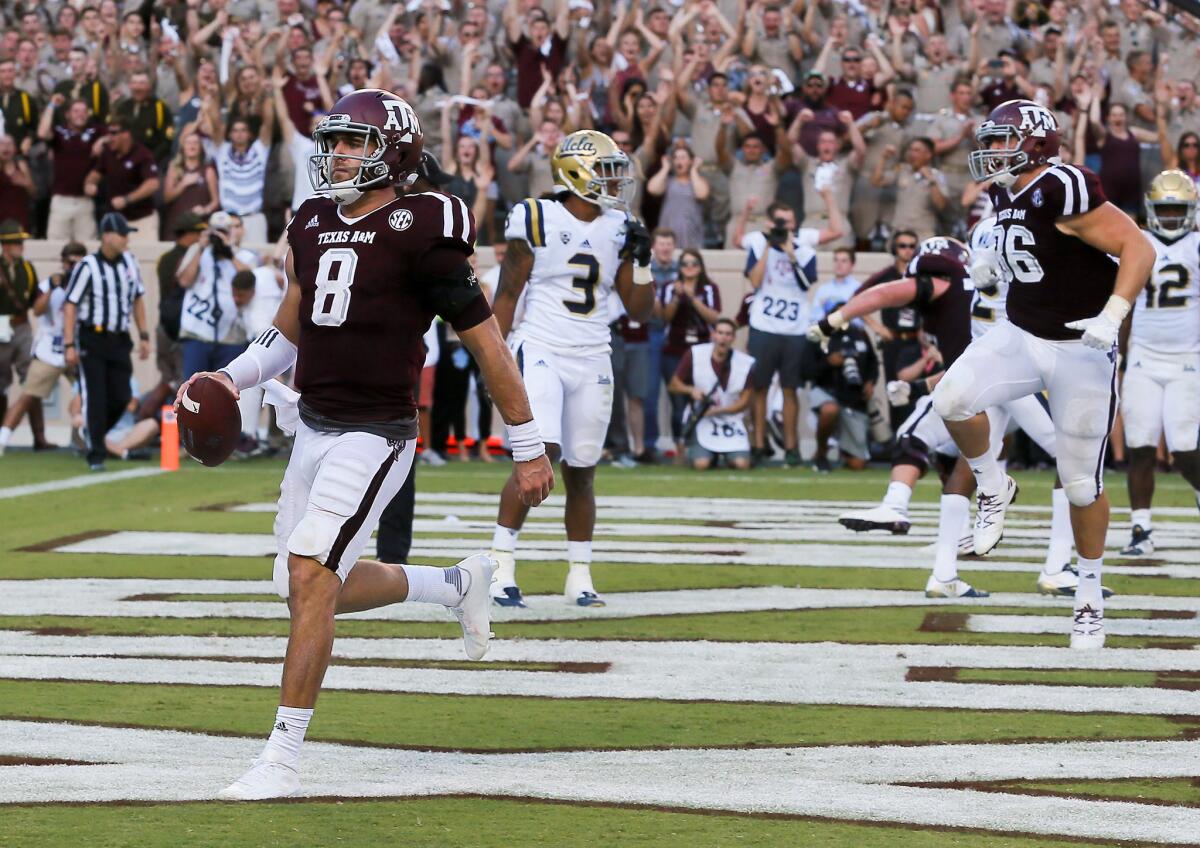 Texas A&M quarterback Trevor Knight (8) scores on a 1-yard run in overtime against UCLA on Sept. 3.