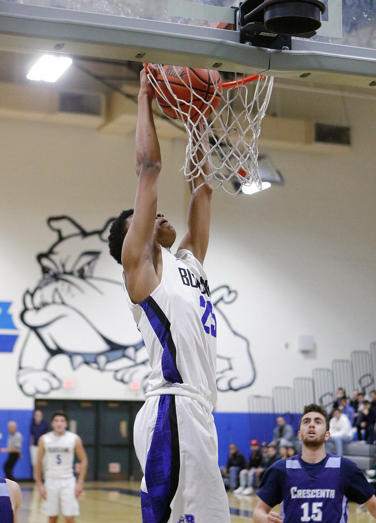 Burbank's Abiel Pearl turns with a steal and dunks it against Crescenta Valley in a Pacific League boys' basketball game at Burbank High School on Thursday, December 19, 2019.