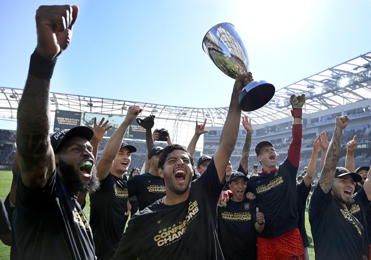 LAFC forward Carlos Vela holds up a trophy after defeating Austin FC in the MLS Western Conference final 