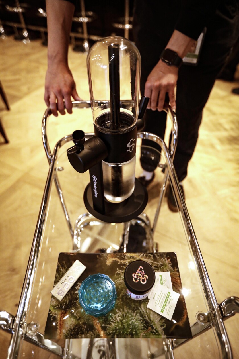 A bar cart stocked with a gravity bong and smoking accoutrements 