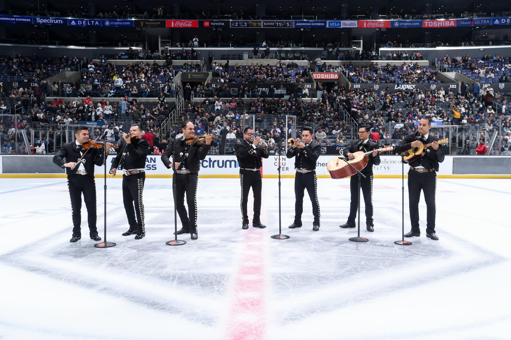 Mariachis perform to celebrate Día de Los Muertos night during the second period of a Kings game