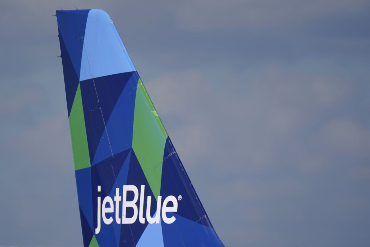 FILE - The tail of a JetBlue Airways Airbus A321 is shown as the plane prepares to take off from Fort Lauderdale-Hollywood International Airport, Tuesday, Jan. 19, 2021, in Fort Lauderdale, Fla. JetBlue Airways is trying to buy Spirit Airlines and break up a plan for Spirit to merge with fellow budget airline Frontier. Spirit said Tuesday, April 5, 2022, that JetBlue offered $33 a share, or about $3.6 billion. (AP Photo/Wilfredo Lee, File)