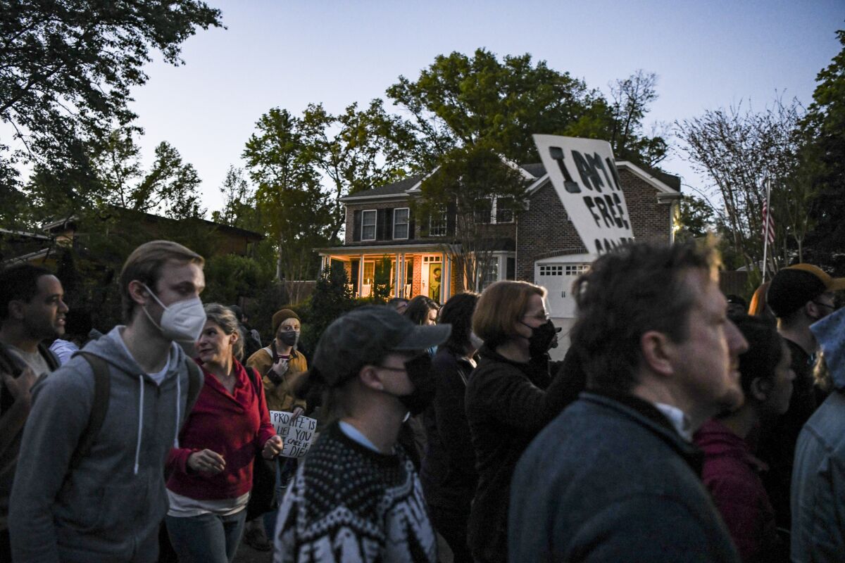 Demonstrators march to Justice Samuel Alito's house for a candlelight vigil as part of an abortion rights protest.