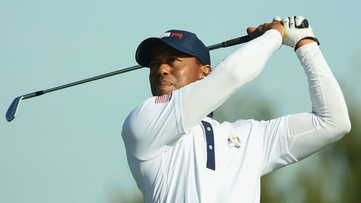 Tiger Woods hits a tee shot during the Ryder Cup in France in September. Woods went 0-4 in his matches.