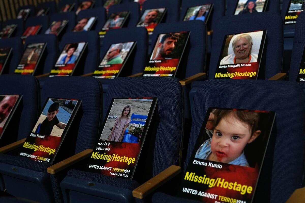 Photographs of people killed or abducted in Hamas' Oct. 7 attack on Israel are displayed in Tel Aviv on Oct. 22. 