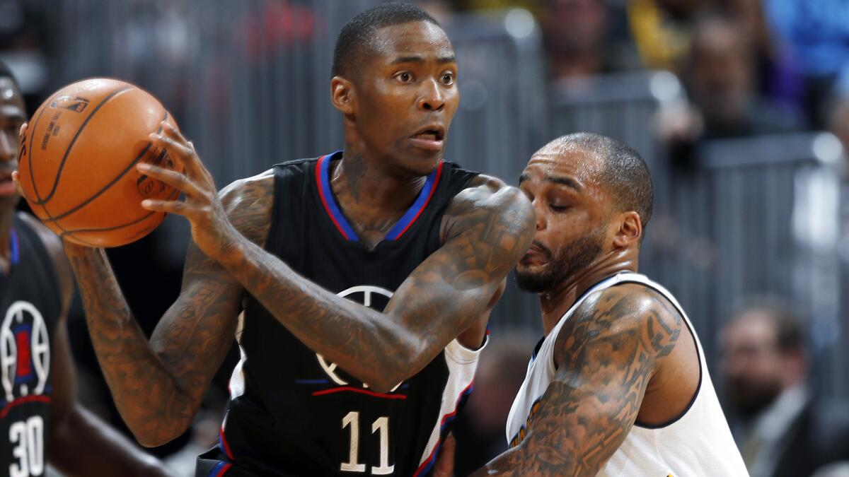 Clippers guard Jamal Crawford looks to pass the ball while being defended by Nuggets guard Jameer Nelson during the second half Saturday night.