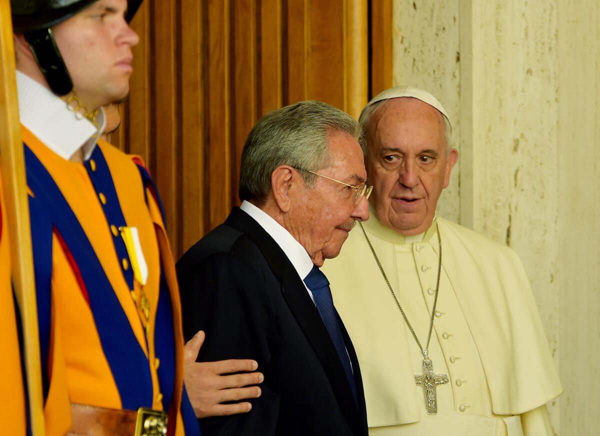 Pope Francis speaks with Cuban President Raul Castro at the Vatican.