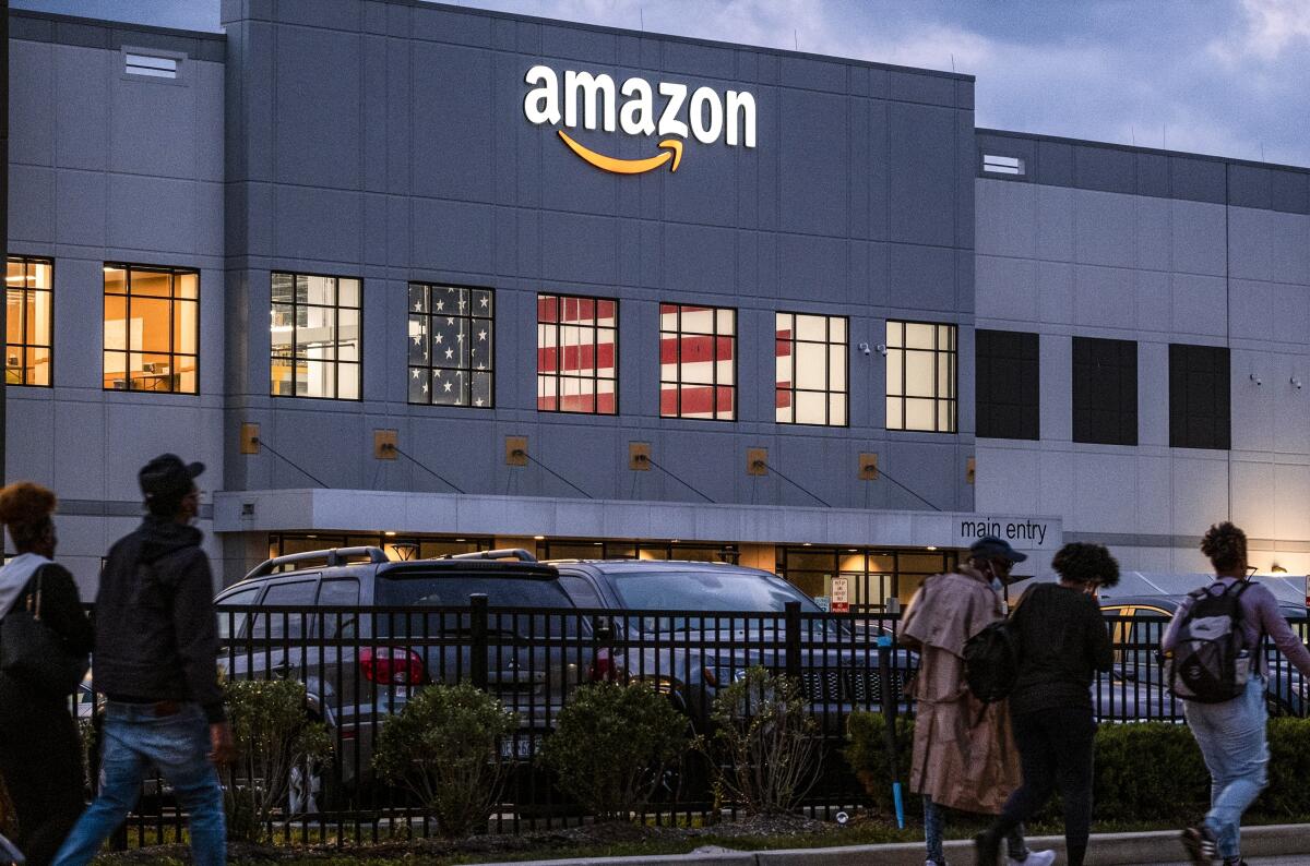 Workers arrive at the Amazon distribution center in the Staten Island, N.Y. in October 2021. 