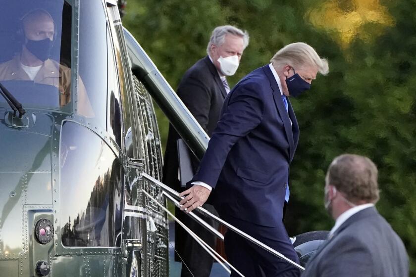 President Donald Trump arrives at Walter Reed National Military Medical Center, in Bethesda, Md., Friday, Oct. 2, 2020, on Marine One helicopter after he tested positive for COVID-19. White House chief of staff Mark Meadows is at second from left. (AP Photo/Jacquelyn Martin)