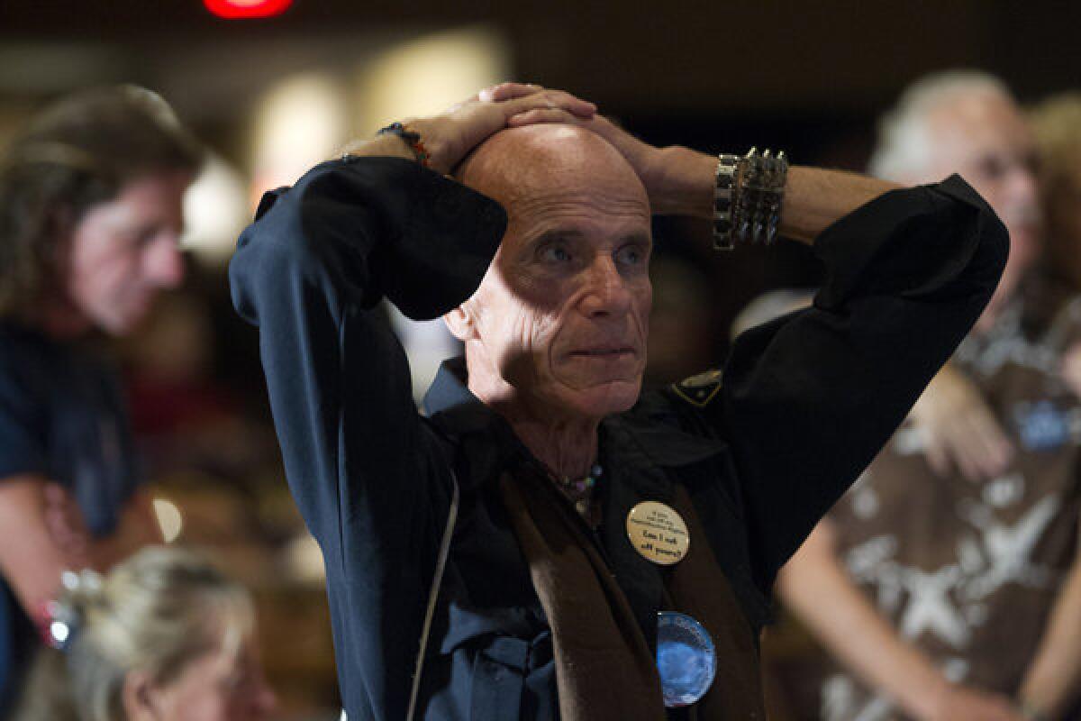 Dennis Eugene Hatton reacts while watching televised reports on the presidential election at an Obama watch party in Fort Myers, Fla.