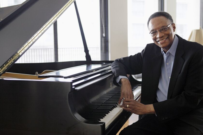 FILE - Jazz pianist and composer Ramsey Lewis describes his composing methods during an interview at his home in Chicago, April 5, 2011. Renowned jazz pianist Lewis, whose music entertained fans over a more than 60-year career that began with the Ramsey Lewis Trio and made him one of the country’s most successful jazz musicians, died Monday, Sept. 12, 2022. He was 87. (AP Photo/M. Spencer Green, File)