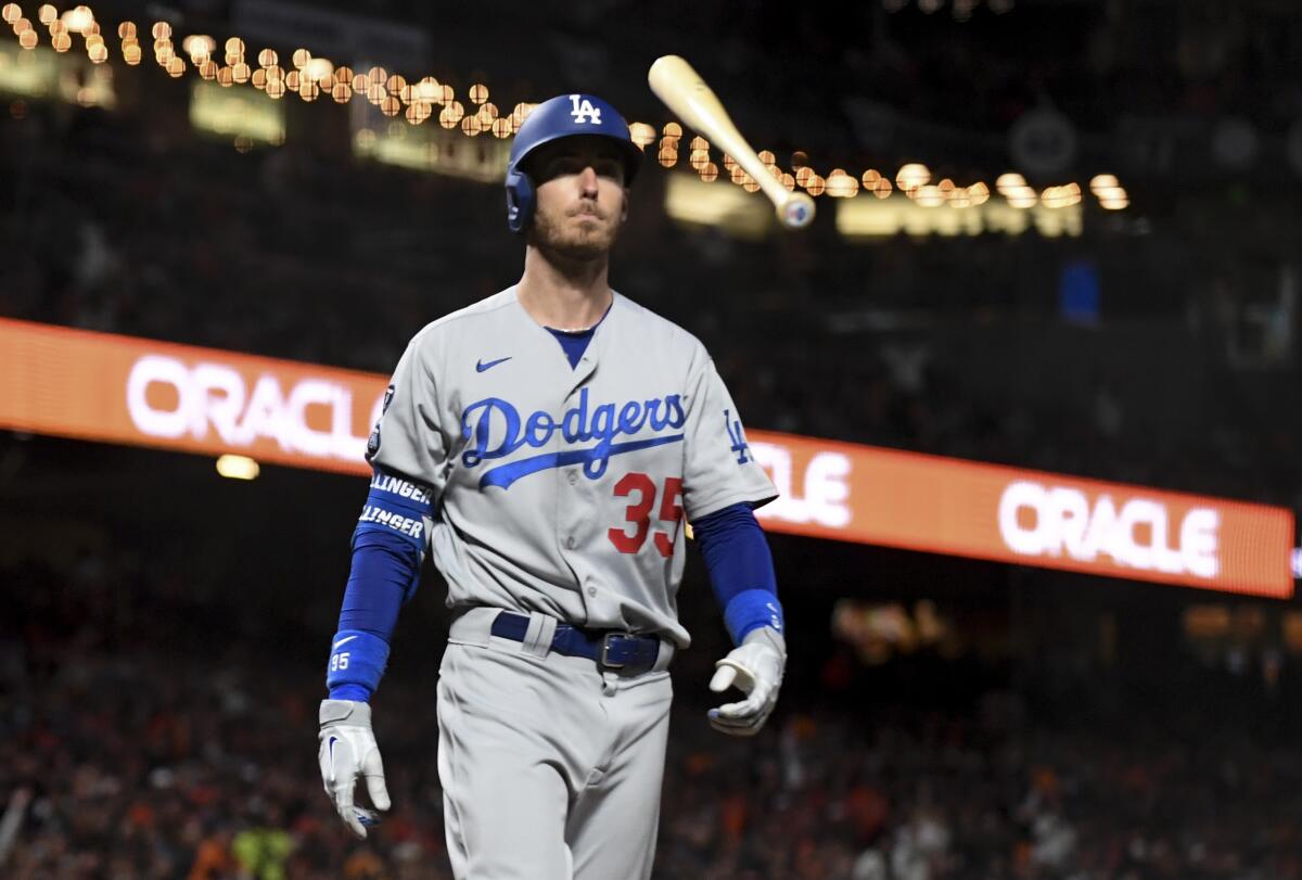 Dodgers batter Cody Bellinger tosses his bat after striking out in the fourth inning.