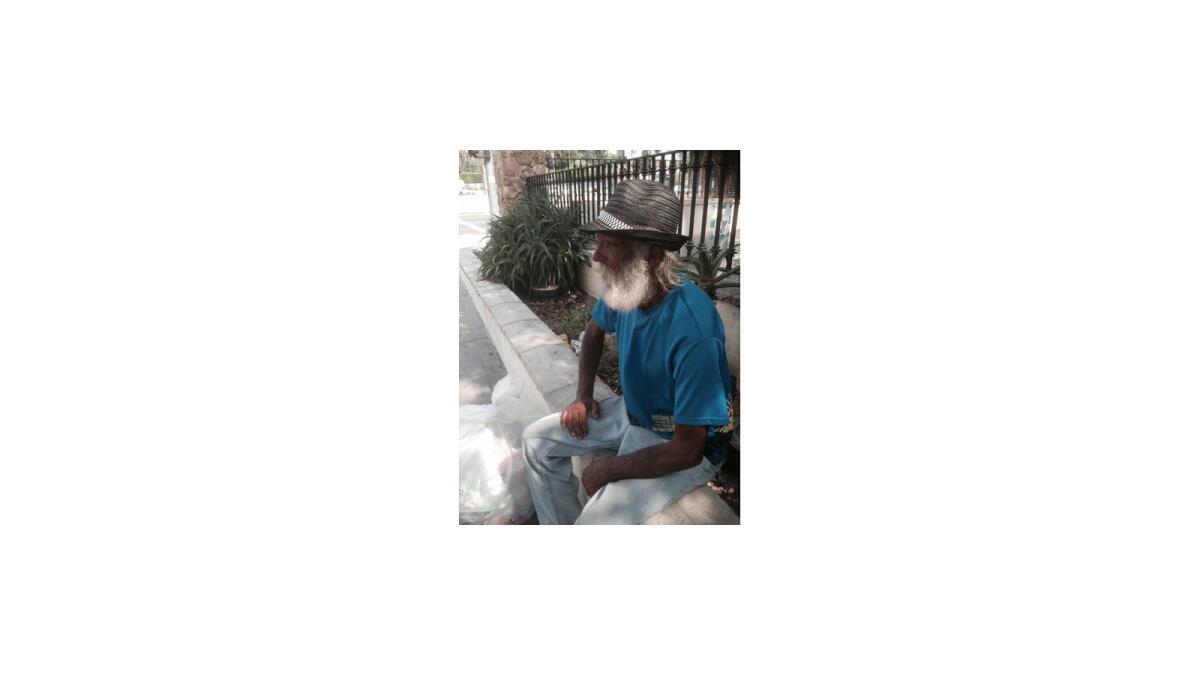 Henry A. Jeffries, 60, of Pomona lost his job as a hotel plumber five years ago and ended up sleeping by the 101 Freeway and Spring Street in downtown Los Angeles. Displaced by a city cleanup Tuesday, he watches over his carts while awaiting his return after the weeklong public works operation.