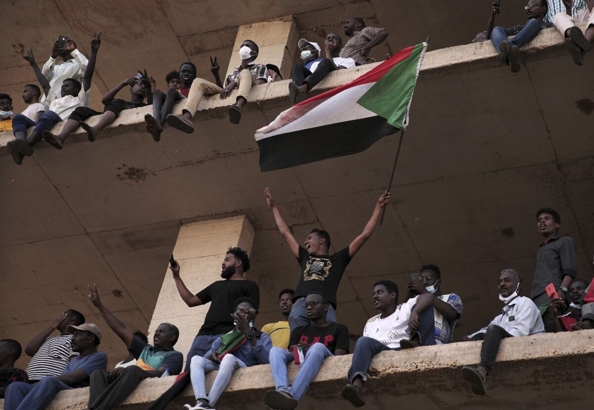 People chant slogans during a protest in Khartoum, Sudan, Saturday, Oct. 30, 2021. Pro-democracy groups called for mass protest marches across the country Saturday to press demands for re-instating a deposed transitional government and releasing senior political figures from detention. (AP Photo/Marwan Ali)