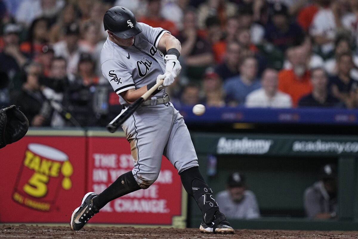 Chicago White Sox's Andrew Vaughn hits a two-run double off Houston Astros relief pitcher Ryan Pressly during the ninth inning of a baseball game Thursday, March 30, 2023, in Houston. (AP Photo/Kevin M. Cox)