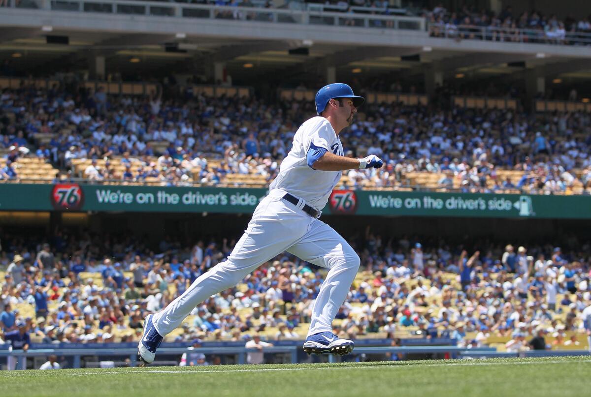 Dodgers first baseman Scott Van Slyke heads toward first base as he watches his solo home run in the second inning Sunday afternoon.