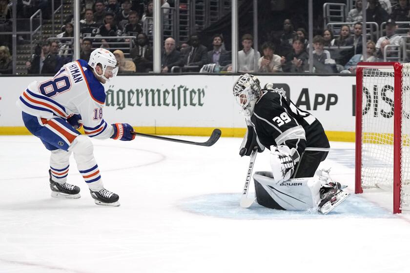Los Angeles Kings goaltender Cam Talbot, right, deflects a shot by Edmonton Oilers left wing Zach Hyman before Hyman scored on the rebound during Game 3 of an NHL hockey Stanley Cup first-round playoff series Friday, April 26, 2024, in Los Angeles. (AP Photo/Mark J. Terrill)