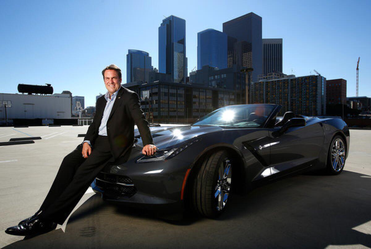 Mark Reuss, President of General Motors, is photographed in downtown Los Angeles next to the company's new 2014 Corvette Stingray convertible. Reuss hinted that a version of the Corvette could be a hybrid.