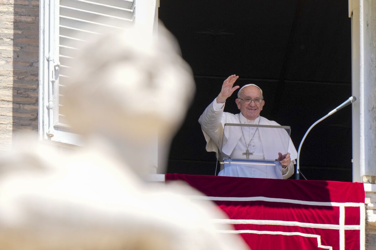 Pope Francis delivers his blessing as he recites the Regina Coeli noon prayer from the window of his studio overlooking St. Peter's Square, at the Vatican, Sunday June 12, 2022. (AP Photo/Andrew Medichini)