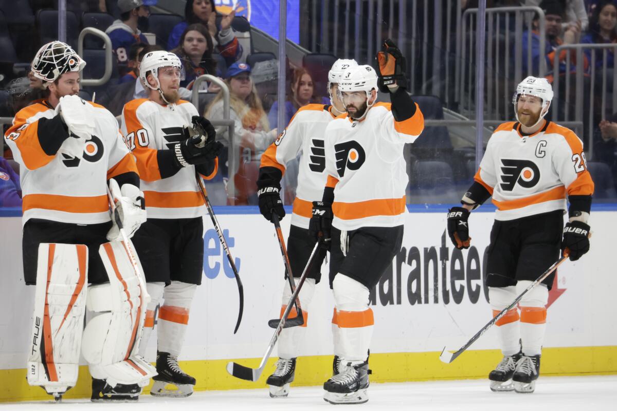 Philadelphia Flyers defenseman Keith Yandle (3) acknowledges the crowd after it is announced that he set NHL's record by playing in his 965th consecutive game in the first period of an NHL hockey game against the New York Islanders, Tuesday, Jan. 25, 2022, in Elmont, N.Y. (AP Photo/Corey Sipkin)