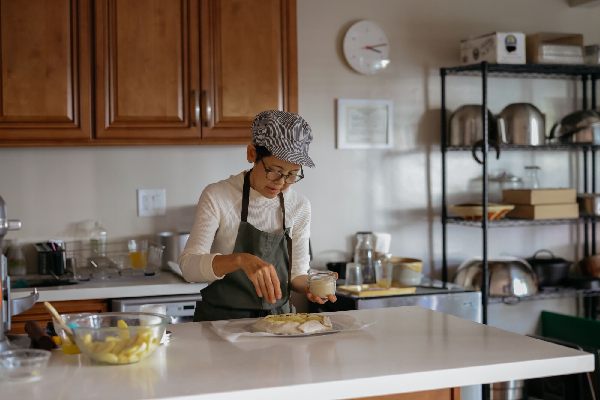 Los Angeles, CA - November 01: Fuyuko Kondo sprinkles sugar on an apple galette at her home