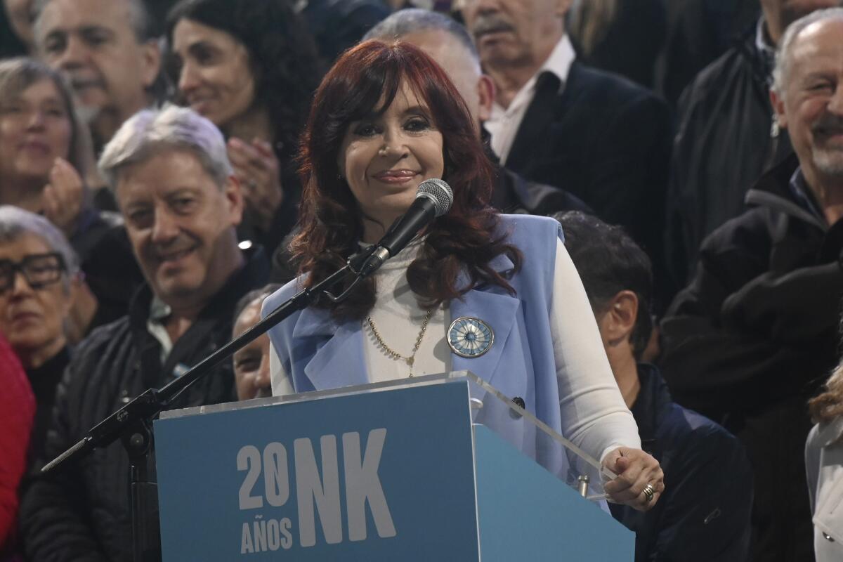 Argentina's Vice President Cristina Fernández de Kirchner smiles onstage behind a lectern