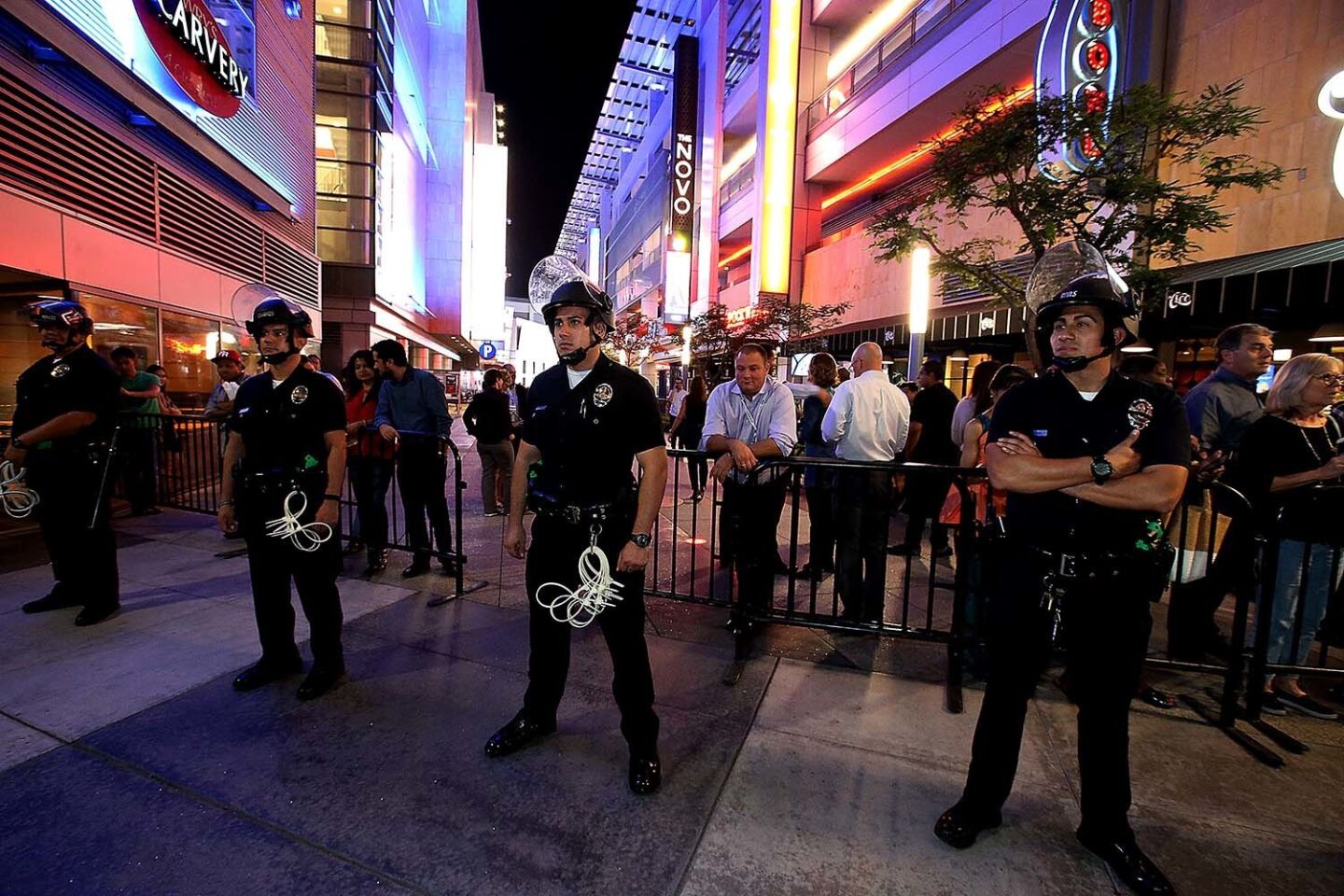Police officers stand guard at LA Live as anti-Trump demonstrators hit the streets.