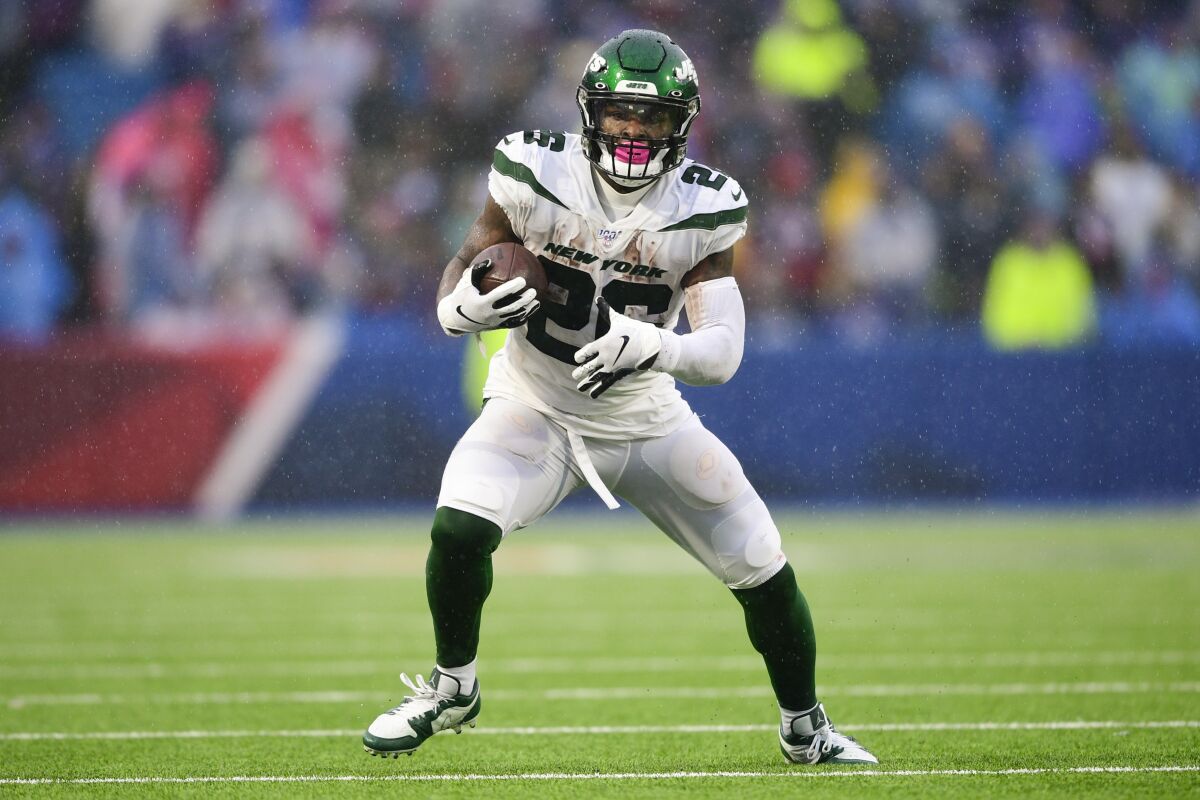 File-This Dec. 29, 2019, file photo shows New York Jets running back Le'Veon Bell (26) during the first half of an NFL football game against the Buffalo Bills in Orchard Park, N.Y. The New York Jets have surprisingly released Bell, ending a disappointing tenure after less than two full seasons. The team issued a statement from general manager Joe Douglas on Tuesday, Oct. 13, 2020, in which he says the Jets made the move after having several conversations with Bell and his agent during the last few days and exploring trade options. (AP Photo/David Dermer, File)