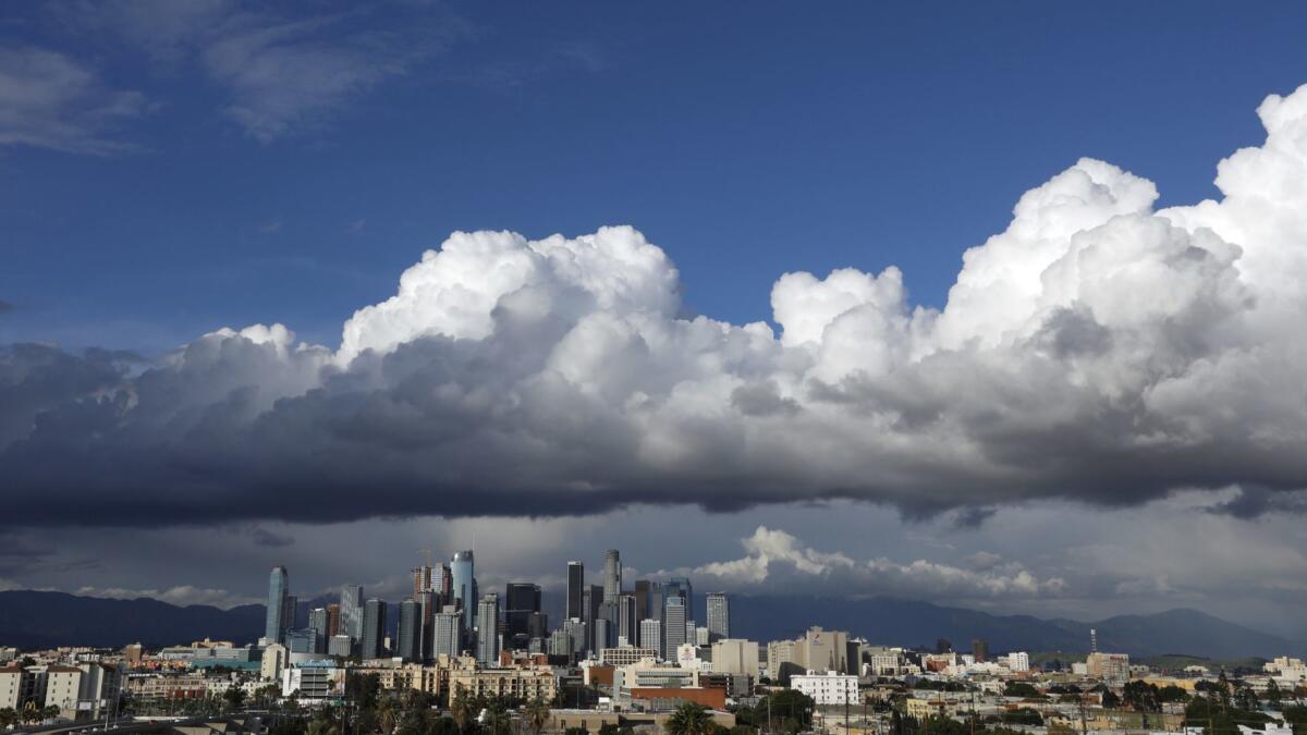 Storm clouds gather ominously over downtown Los Angeles on the first day of spring.