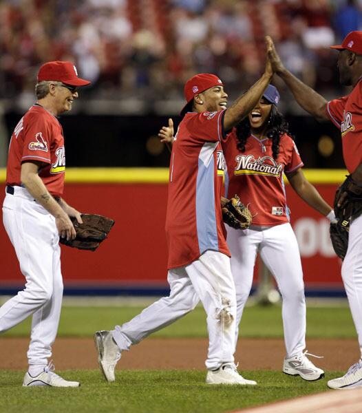 Billy Bob Thornton, Nelly and Trena Peel celebrate during the Taco Bell All-Star Legends & Celebrity Softball Game at Busch Stadium on July 12, 2009 in St. Louis, Missouri.
