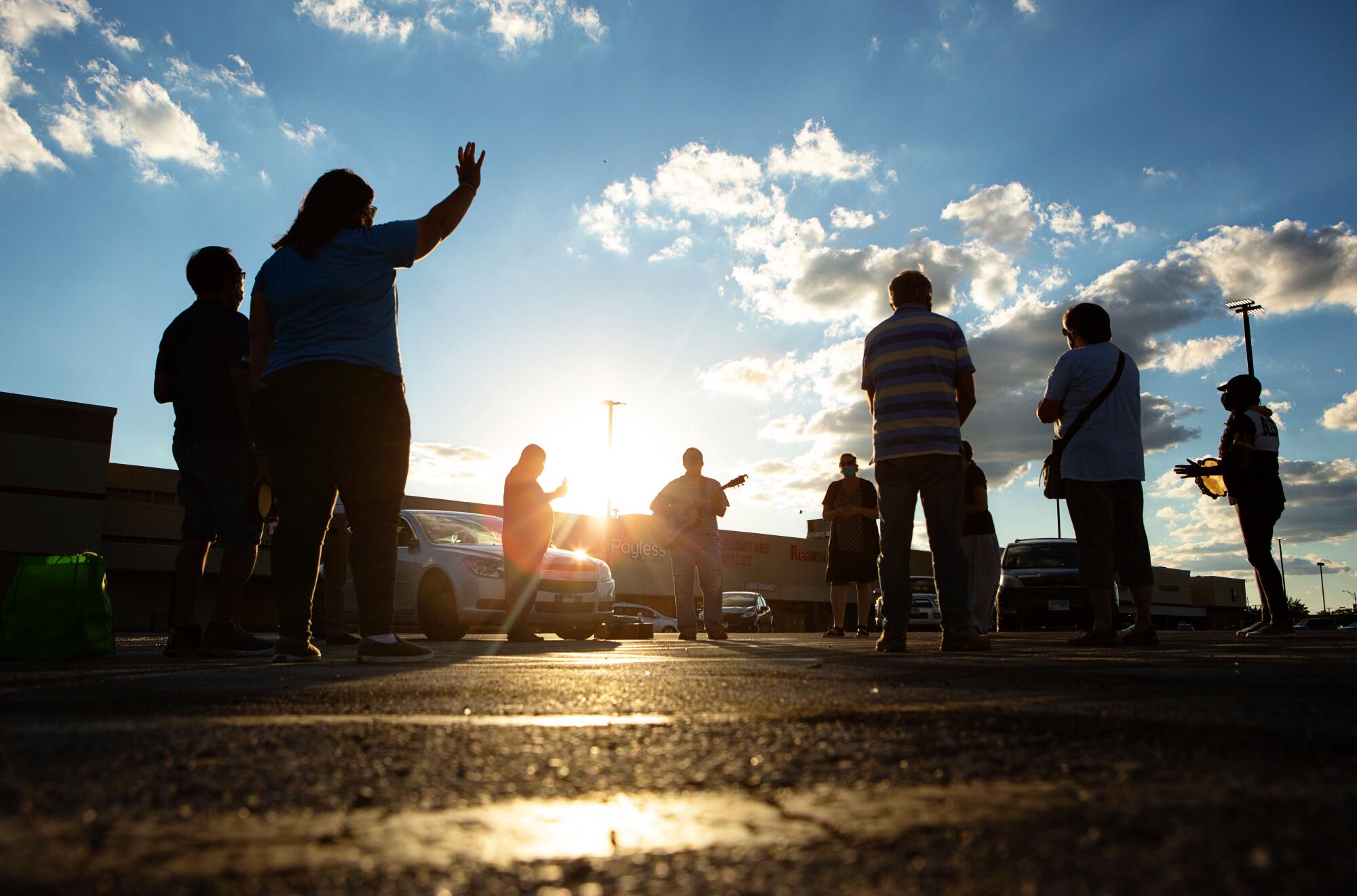 Donovan Price leads a prayer at a weekly service in a strip mall parking lot on Chicago's South Side.