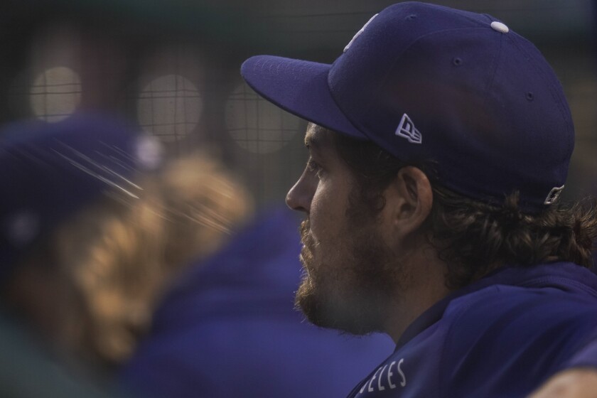 Trevor Bauer watches from the dugout as the Dodgers play the Washington Nationals 