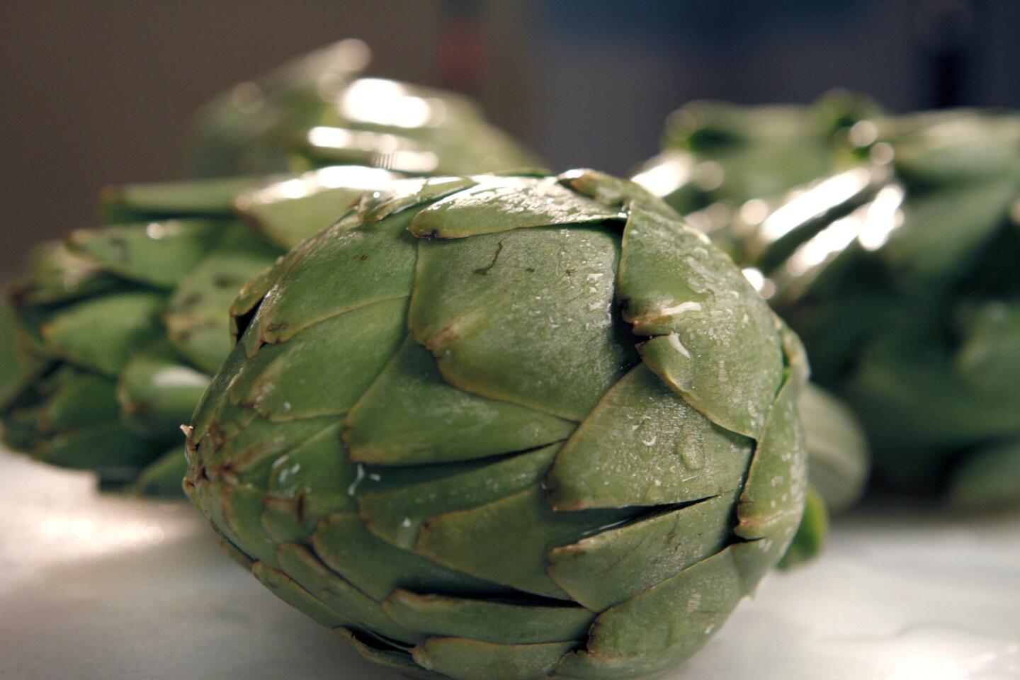 Steam artichokes first, then a quick grill for flavor. Recipe: Smoked chicken and grilled artichoke salad