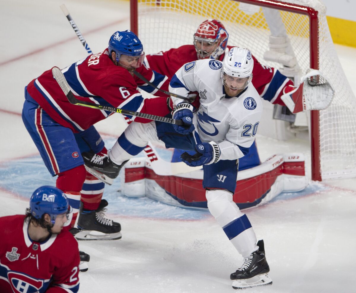 Montreal Canadiens' Shea Weber (6) clears Tampa Bay Lightning's Blake Coleman (20) in front of Canadiens goaltender Carey Price (31) during the first period of Game 4 of the NHL hockey Stanley Cup final in Montreal, Monday, July 5, 2021. (Ryan Remiorz/The Canadian Press via AP)