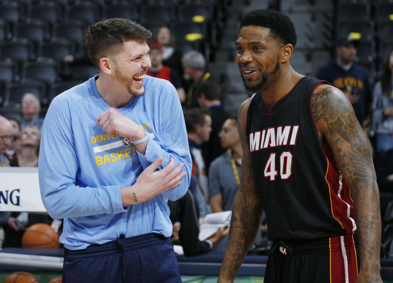 Denver Nuggets guard Mike Miller, left, jokes with former teammate Miami Heat forward Udonis Haslem during warmups before the first half of an NBA basketball game Friday, Jan. 15, 2016, in Denver. (AP Photo/David Zalubowski) ORG XMIT: CODZ101