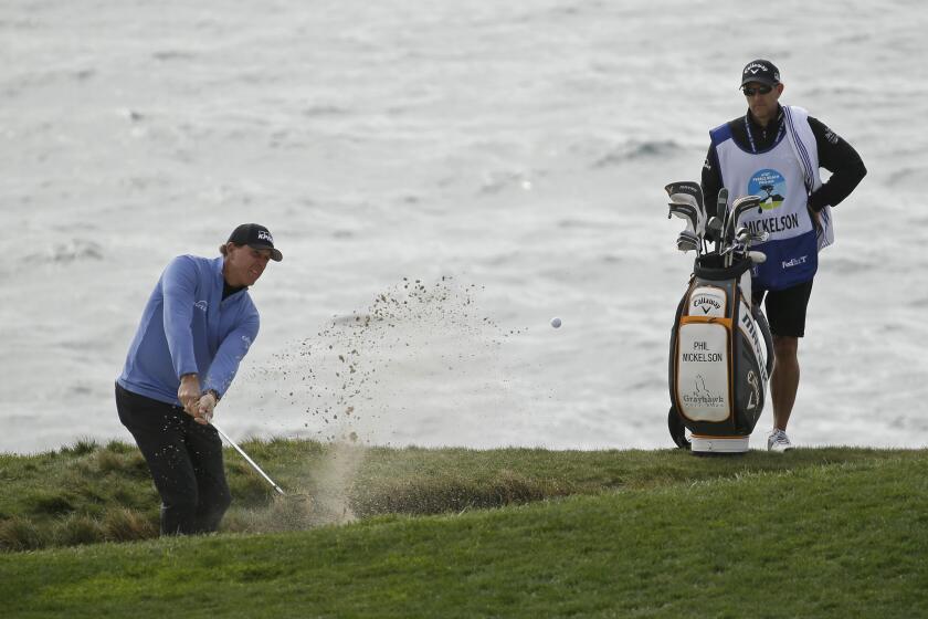 Phil Mickelson chips the ball out of a bunker up to the seventh green of the Pebble Beach Golf Links during the third round of the AT&T Pebble Beach National Pro-Am golf tournament Saturday, Feb. 8, 2020, in Pebble Beach, Calif. (AP Photo/Eric Risberg)