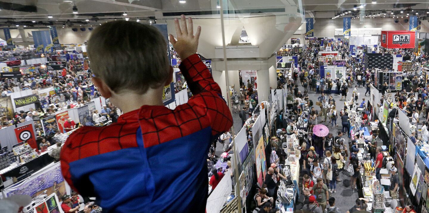 Spider-Man fan Adi Goldman, 6, of Santa Monica looks at the crowds filling the San Diego Convention Center on opening day of Comic-Con.