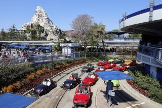 Anaheim, CA - March 11: Visitors wait in lines inside their idling cars at the end of the ride at Autopia in Tomorrowland at Disneyland. Environmental activists Zan Dubin and Paul Scott, not shown, recently filed a complaint about air pollution and noxious smells from Autopia with Southern California air quality regulators at Disneyland in Anaheim Monday, March 11, 2024. They want Disneyland to convert Autopia to electric vehicles, and to find other ways -in Tomorrowland and across the park - to bring clean energy into its storytelling. (Allen J. Schaben / Los Angeles Times)