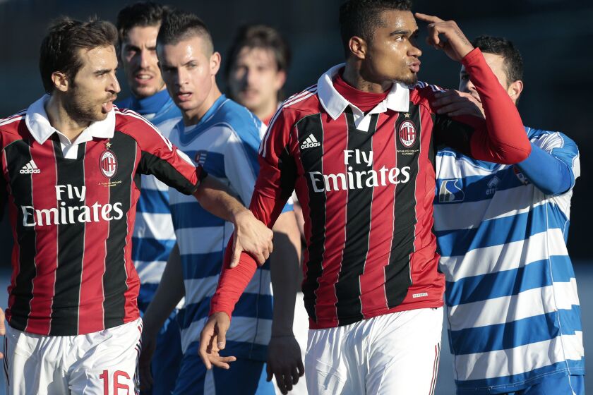FILE - AC Milan midfielder Kevin-Prince Boateng gestures towards the crowd as he leaves the field after being subjected to racial abuse during a friendly soccer match in Busto Arsizio, near Milan, Italy, Thursday, Jan. 3, 2013. Boateng set soccer on a path toward tougher sanctions in cases of discrimination when he walked off the field to protest racial abuse by an opposing team's fans a decade ago. His teammates had his back when he refused to tolerate the abuse from fans of a small provincial Italian club during a mid-season exhibition game in 2013.(AP Photo/Emilio Andreoli, File)