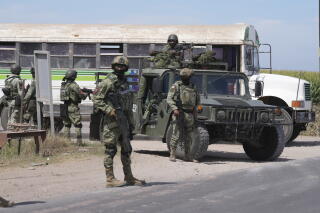 Soldiers patrol a highway in Villa Juarez, outside of Culiacan, Sinaloa.