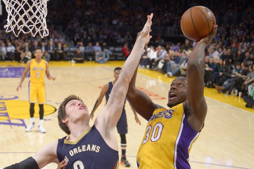 Lakers forward Julius Randle, right, shoots against New Orleans forward Luke Babbitt on Tuesday night.